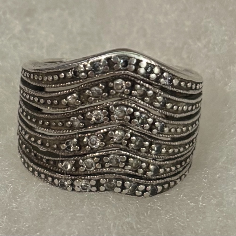 Sterling Silver wave ring features intricate detailing and diamond accents